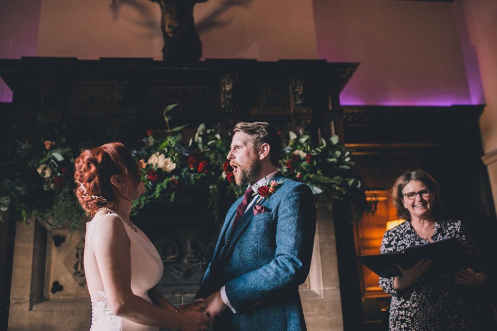 Celebrant for your wedding? bride and groom laughing with celebrant in background at Huntsham Court