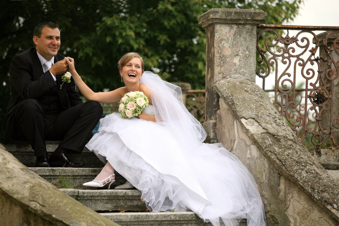what is a wedding celebrant? A bridal couple sat on stone steps after their celebrant ceremony