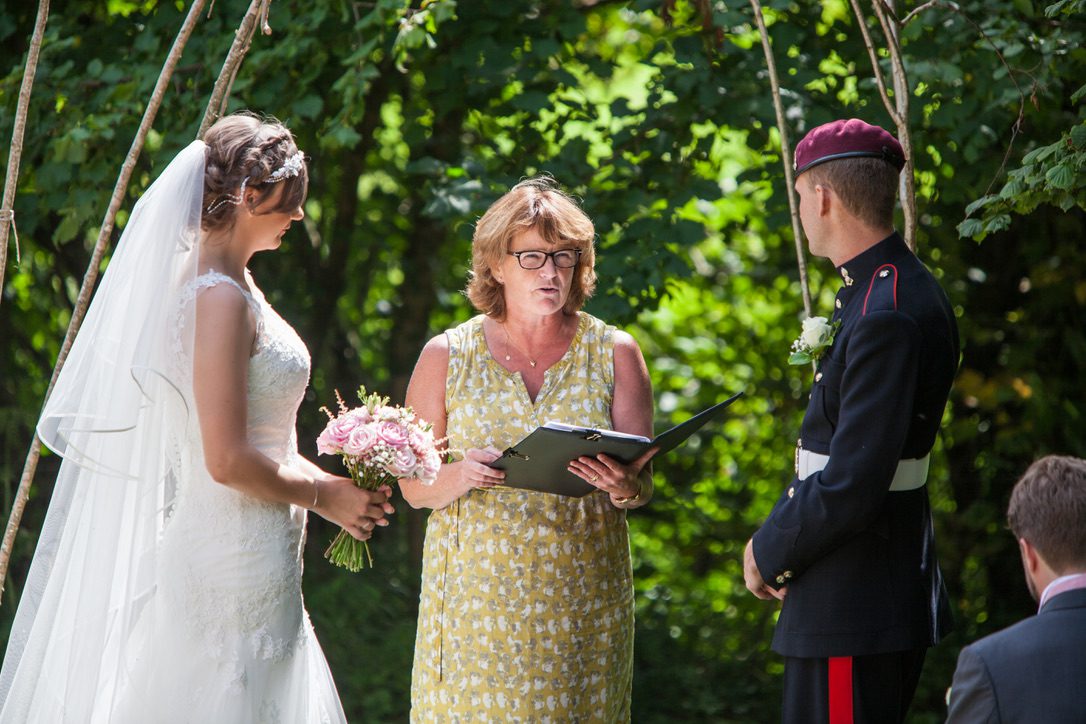 Fan, here in a sleeveless dress, is holding a ceremony for a traditional bride and a groom in military uniform