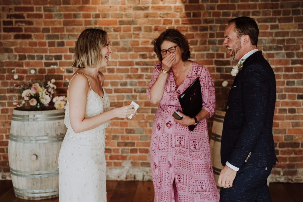 couple renewing their vows with celebrant fanfare ceremonies in pink dress