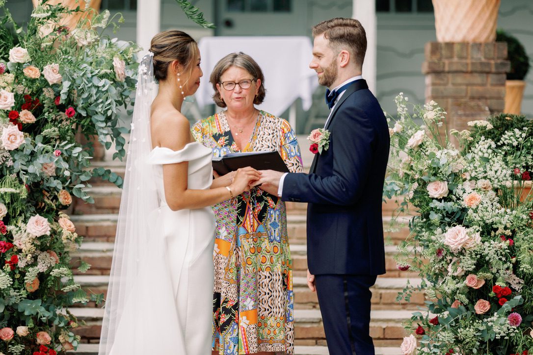 Do registrars offer personal ceremonies like this one? Here a female celebrant is overseeing the wedding of a bride and groom outside