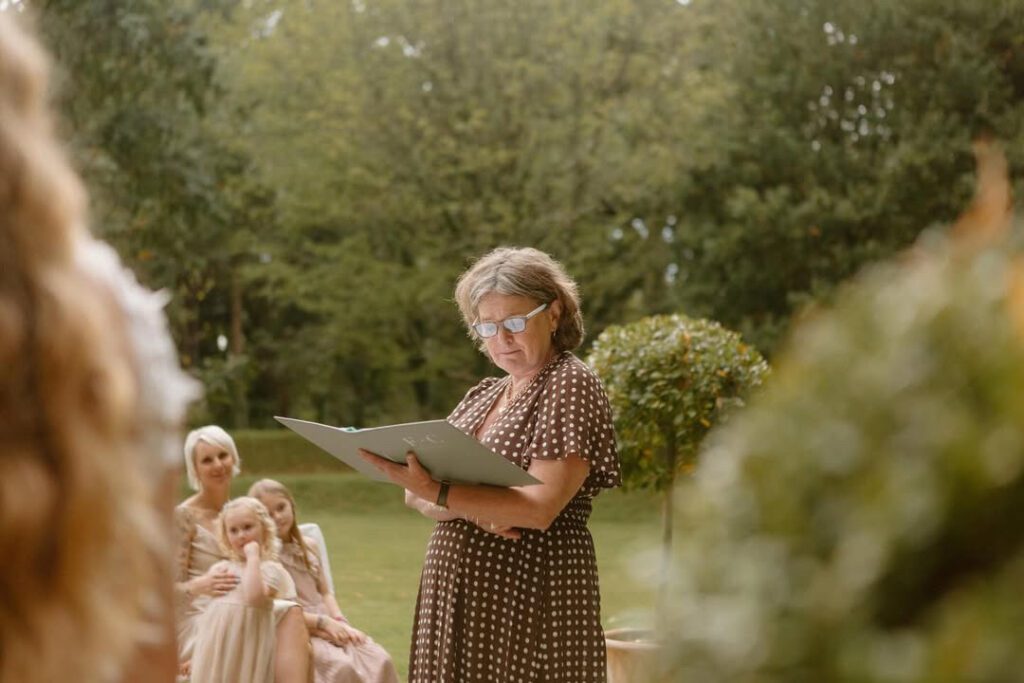 fan of fanfare ceremonies wearing spotted dress leading a ceremony at Deer Park Country House