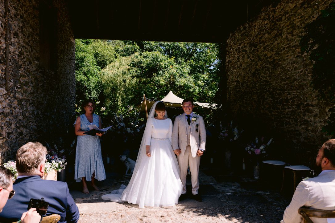 Your unique story told by Fan, dressed in blue, in this outdoor wedding. The Bridal couple are under the shade of a bridge.