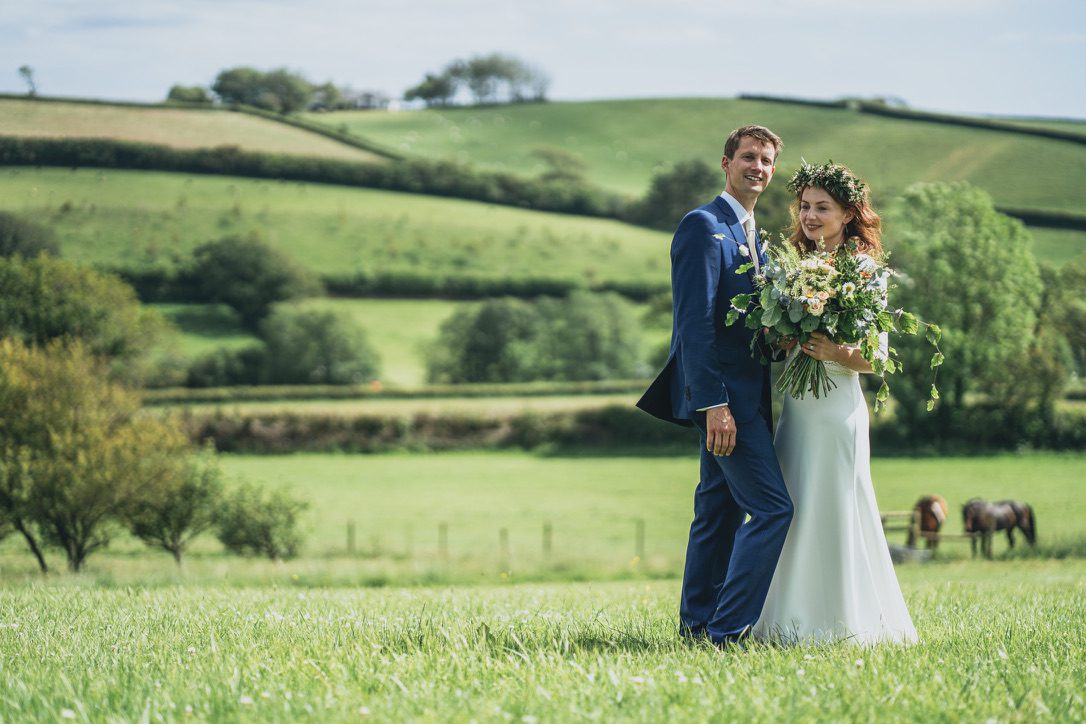 A bride and groom in a field