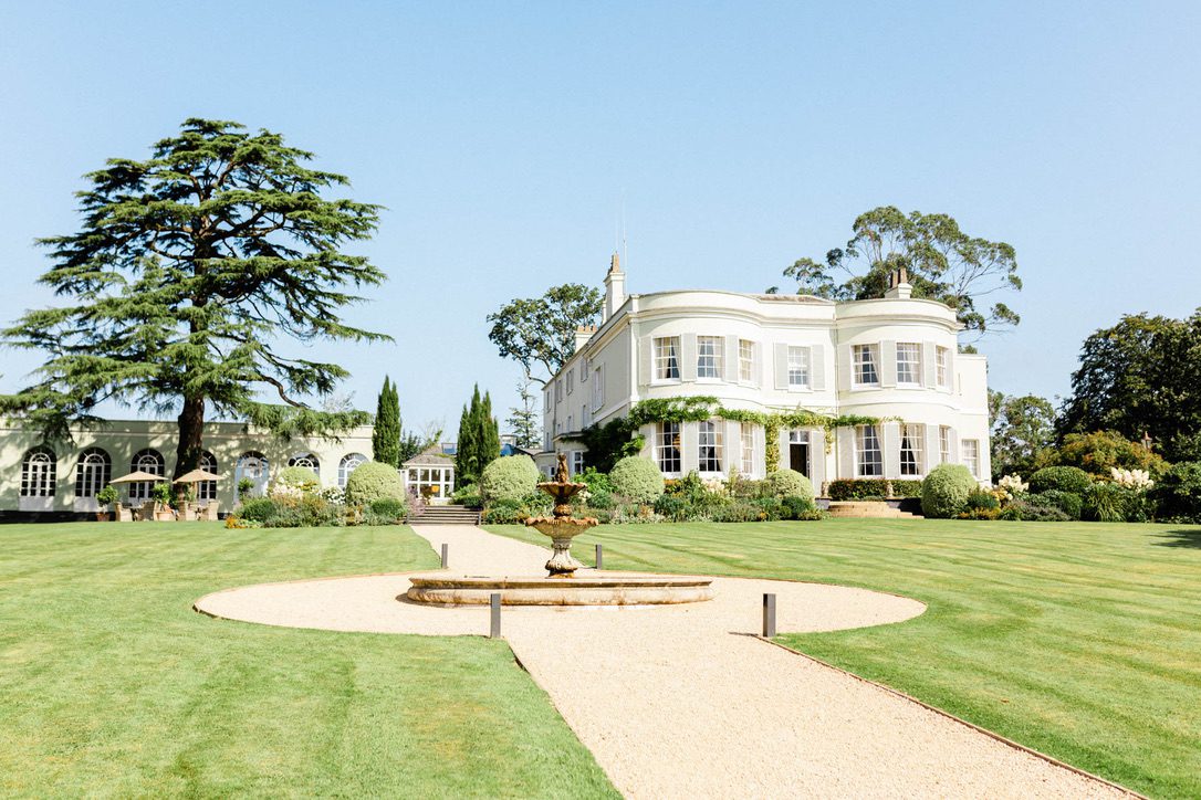 Deer Park Country House image shows house and orangery with gardens and fountain in foreground