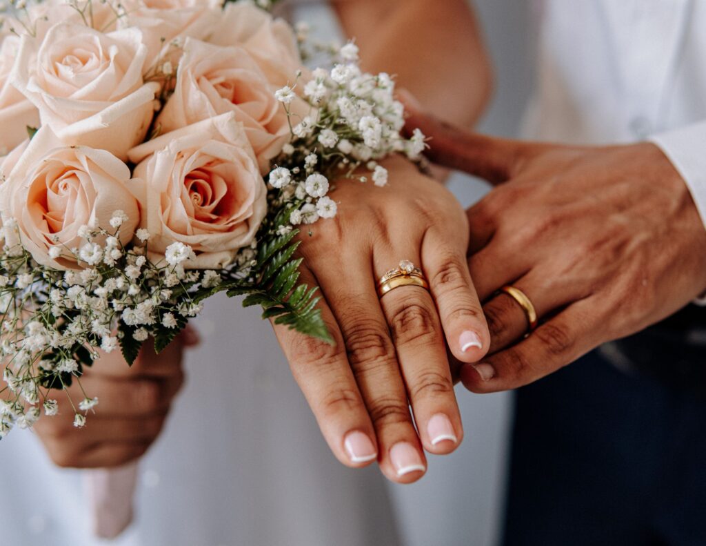 apricot rose bouquet and male and female hand with wedding rings vow renewals 