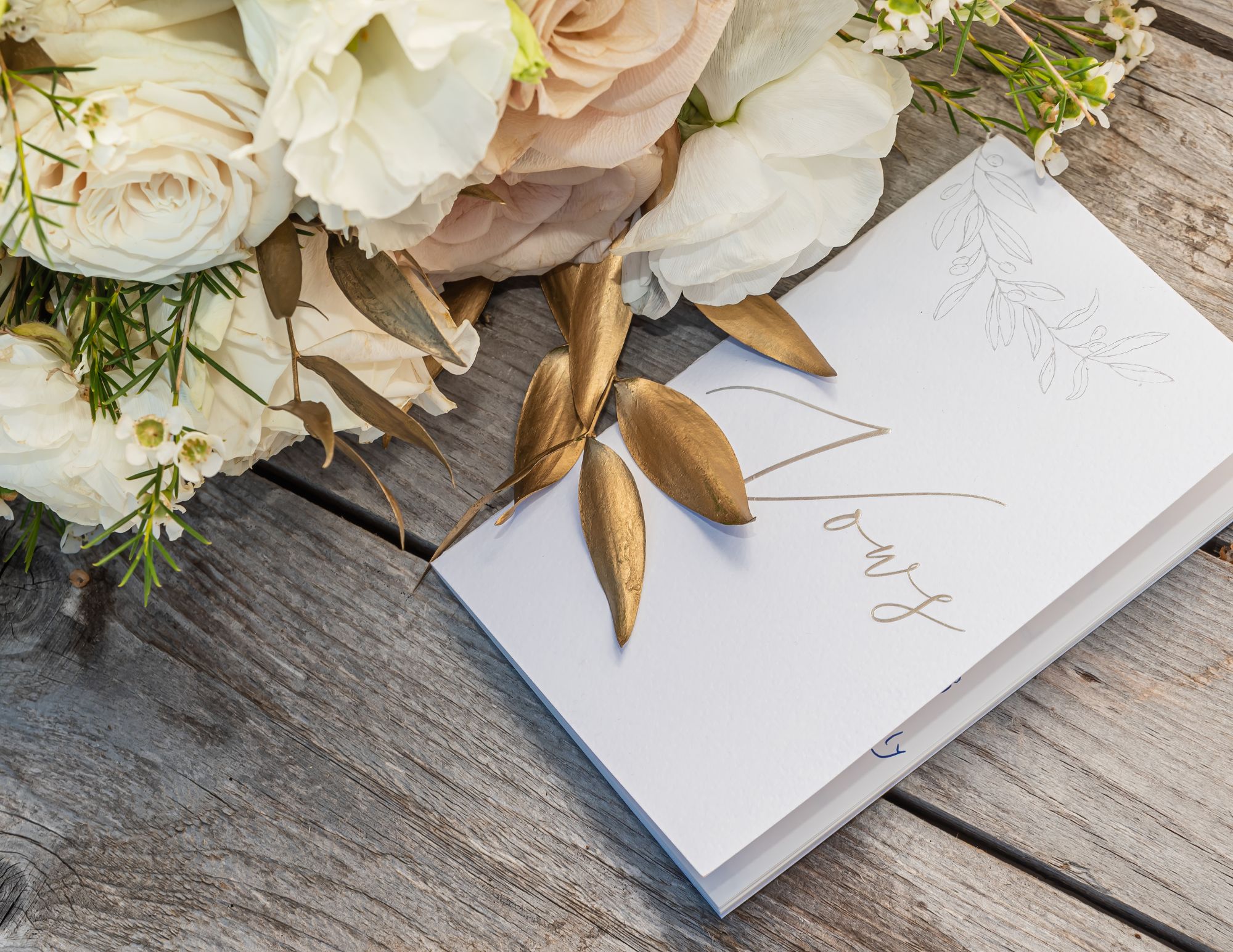 image of vows and bouquet on wooden table for vow renewals blog