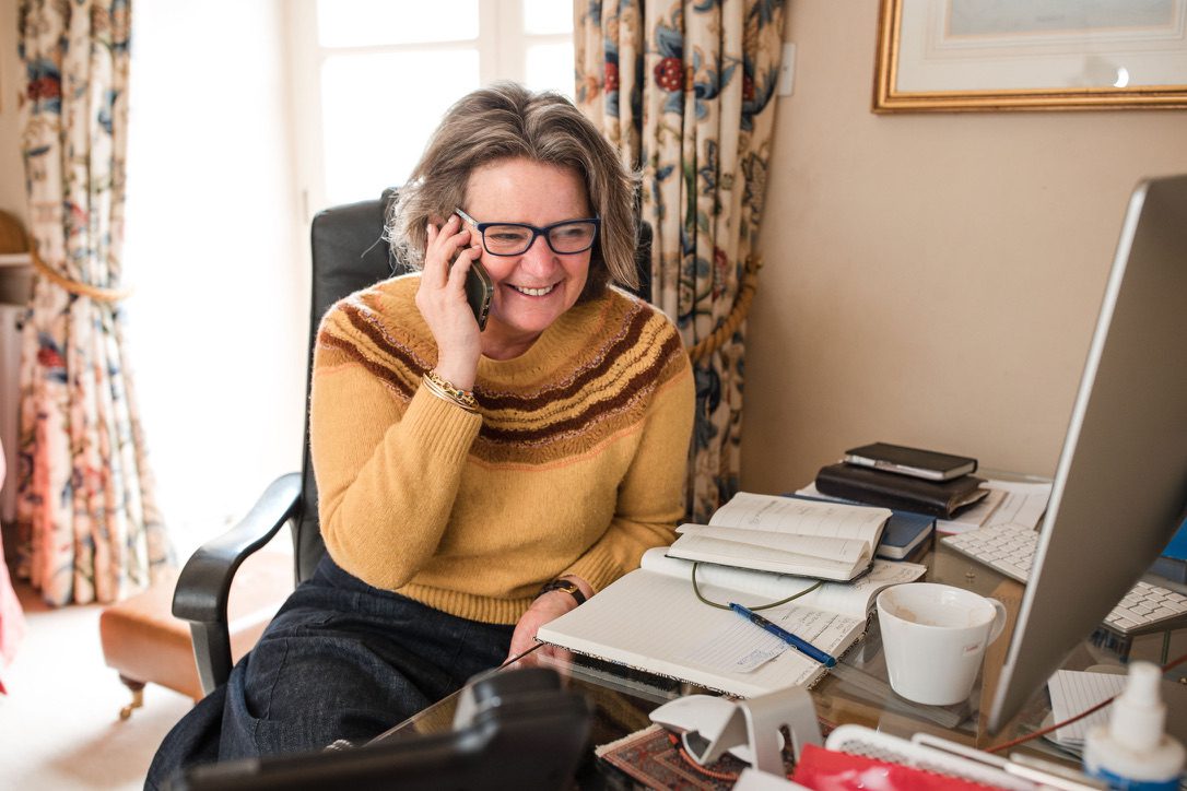 A personalised wedding ceremony outside with a summerhouse in the background. The bride and groom in traditional dress are exchanging vows in front of their guests with Fan leading the ceremony.