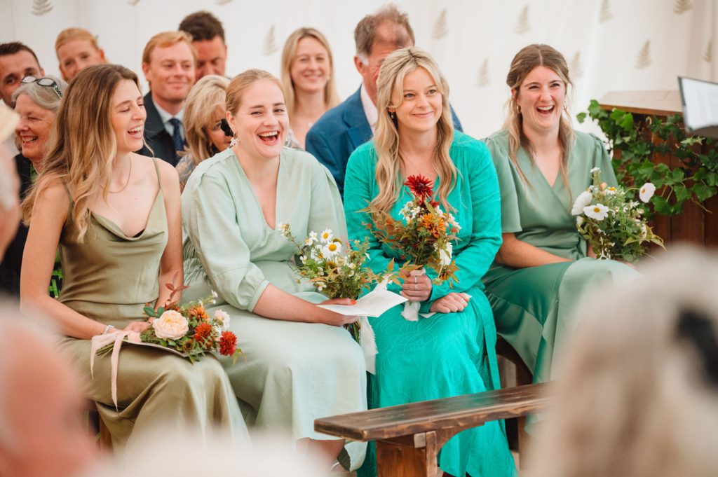 guests and bridesmaids reacting to the content of the wedding ceremony script 