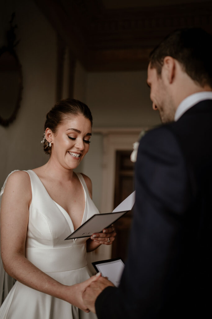 A bride reading her wedding ceremony vows to her groom